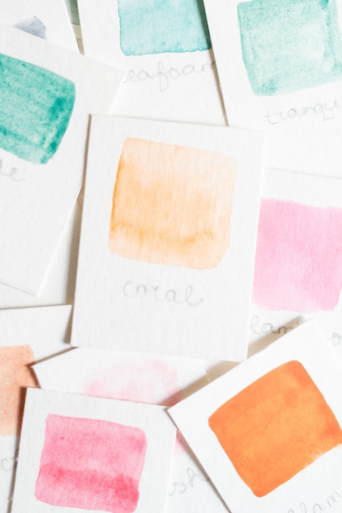 A collection of vibrant watercolor swatches in various hues on white paper.