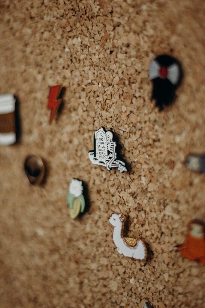 An assortment of pins on a corkboard to stay organized while you complete your Halloween bucket list.